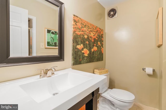 bathroom with visible vents, tile patterned flooring, toilet, and vanity