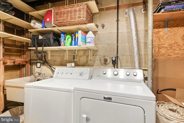 laundry room with separate washer and dryer, laundry area, and a sink