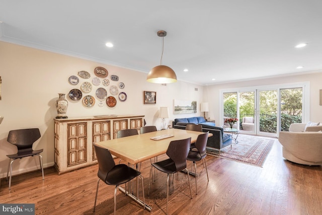 dining area with recessed lighting, ornamental molding, and light wood-style floors