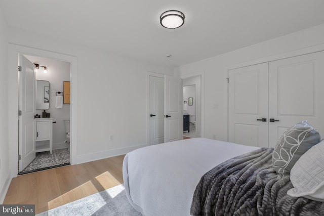 1904 Jackson St NE, Washington, DC 20018 - bedroom with light wood-style floors, baseboards, ensuite bathroom, and a closet