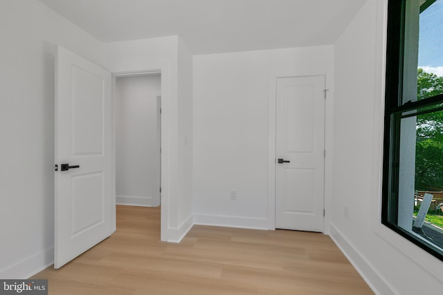 1904 Jackson St NE, Washington, DC 20018 - unfurnished bedroom with light wood-style floors, baseboards, and multiple windows