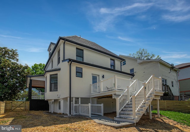 1904 Jackson St NE, Washington, DC 20018 - back of property featuring stucco siding, fence, stairway, and a deck