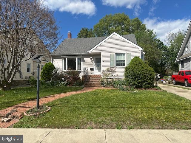 view of front of house with a front lawn and a chimney