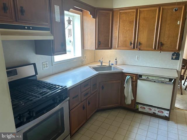 919 Belmont Ave, Haddon Township, NJ 08108 - kitchen with stainless steel gas range, a sink, dishwasher, light countertops, and light tile patterned floors