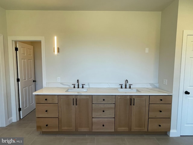 bathroom featuring tile patterned flooring, a sink, and double vanity