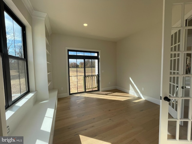 unfurnished room featuring french doors, recessed lighting, baseboards, and wood finished floors