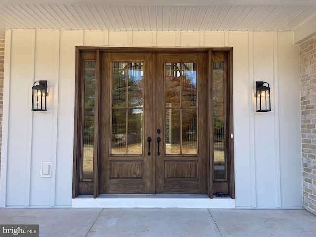 entrance to property featuring board and batten siding and french doors