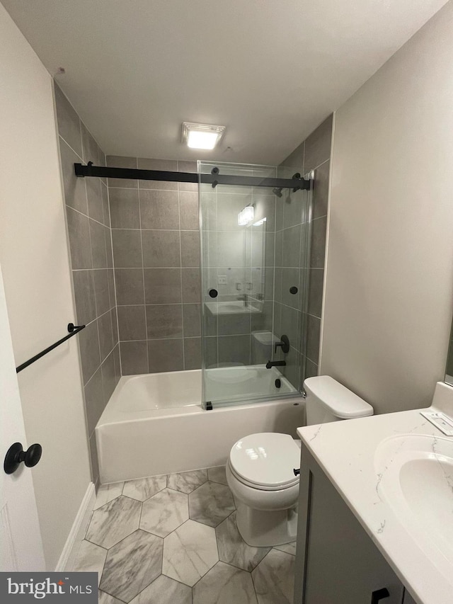 full bathroom featuring vanity, enclosed tub / shower combo, toilet, and marble finish floor