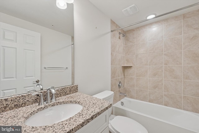 bathroom featuring visible vents, shower / tub combination, toilet, and vanity