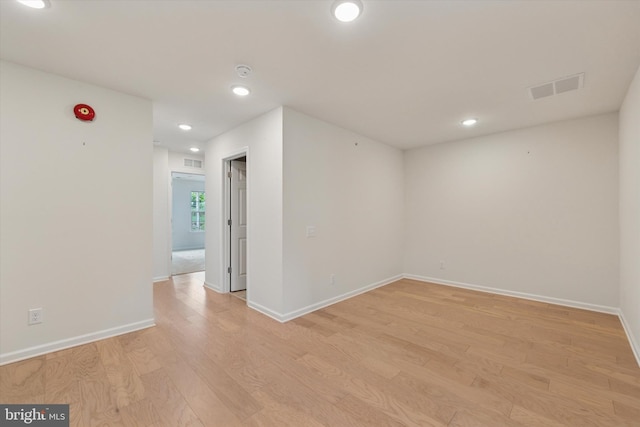 unfurnished room featuring recessed lighting, baseboards, light wood finished floors, and visible vents