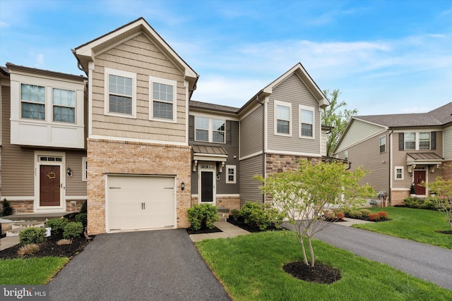 view of front of home with stone siding, a garage, aphalt driveway, brick siding, and a front yard
