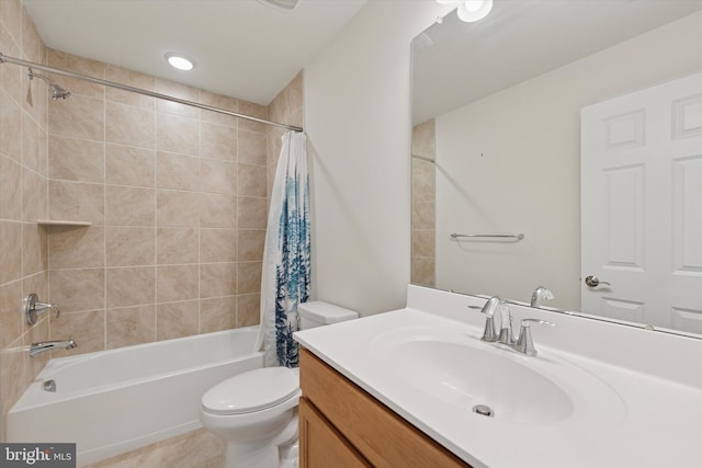 full bath with vanity, toilet, tile patterned floors, and shower / tub combo