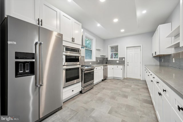 1724 N 62nd St, Philadelphia, PA 19151 - kitchen with appliances with stainless steel finishes, open shelves, backsplash, white cabinets, and recessed lighting