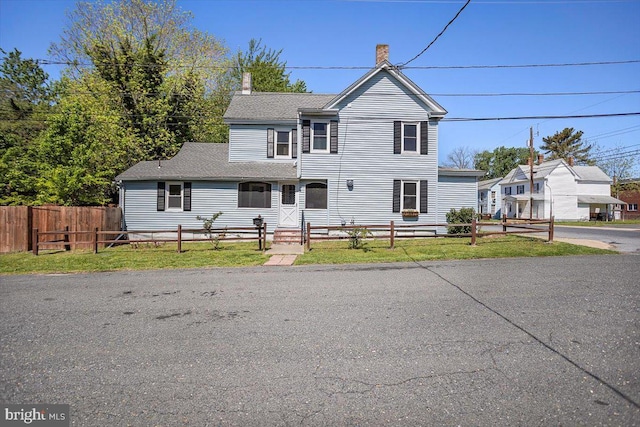 223 Henry St, Cambridge, MD 21613 - traditional-style house featuring a fenced front yard, a shingled roof, and a chimney