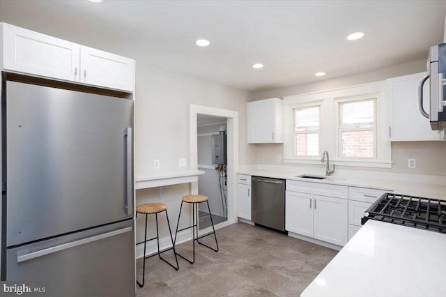 223 Henry St, Cambridge, MD 21613 - kitchen featuring white cabinets, a sink, light countertops, stainless steel appliances, and recessed lighting