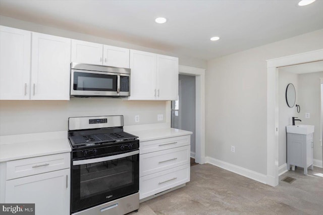 223 Henry St, Cambridge, MD 21613 - kitchen featuring light countertops, stainless steel appliances, recessed lighting, and white cabinetry