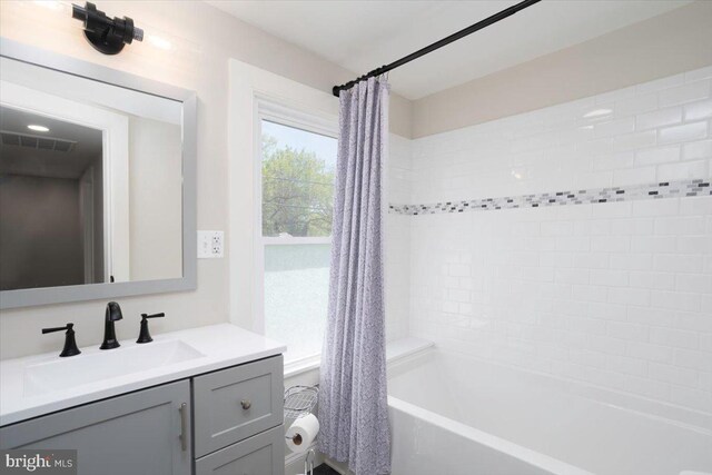 223 Henry St, Cambridge, MD 21613 - bathroom featuring vanity, shower / bathtub combination with curtain, and visible vents