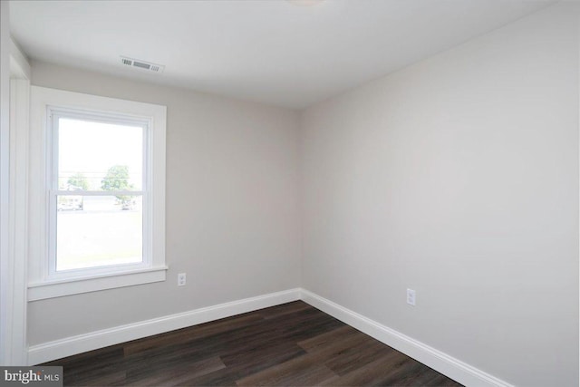 223 Henry St, Cambridge, MD 21613 - empty room with baseboards, dark wood-type flooring, and visible vents