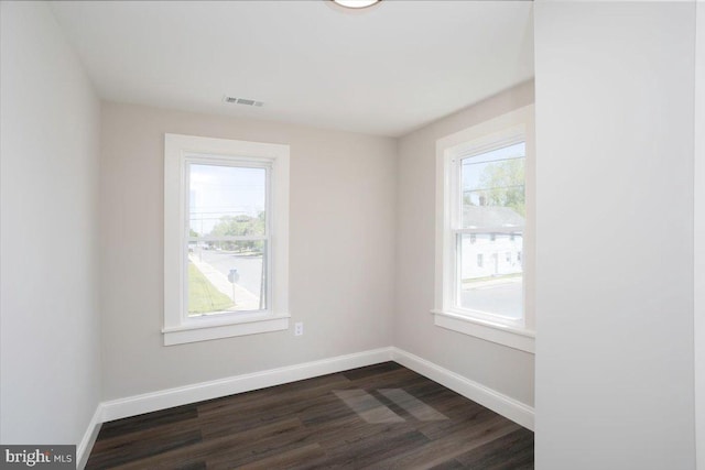 223 Henry St, Cambridge, MD 21613 - empty room with baseboards, visible vents, and dark wood finished floors