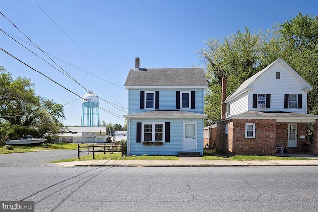 223 Henry St, Cambridge, MD 21613 - traditional-style house featuring fence and a chimney