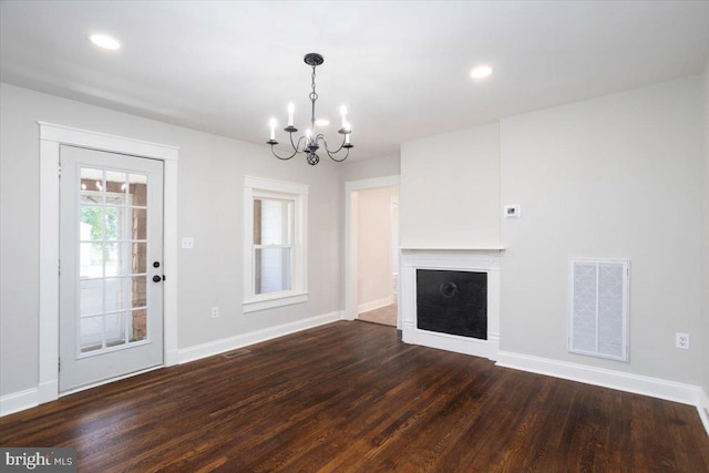 223 Henry St, Cambridge, MD 21613 - unfurnished living room featuring baseboards, a notable chandelier, dark wood-style flooring, and visible vents