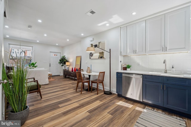 1544 N Allison St, Philadelphia, PA 19131 - kitchen with wood finished floors, light countertops, a sink, dishwasher, and blue cabinetry