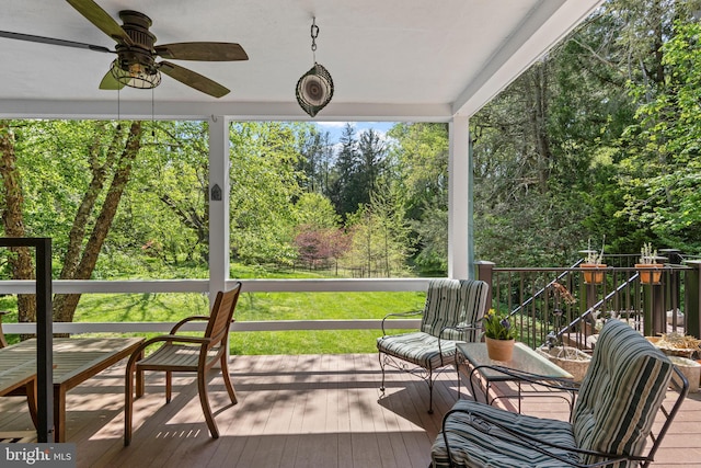wooden deck featuring a ceiling fan