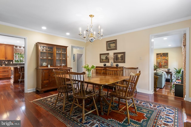 dining space featuring dark wood-type flooring, a chandelier, crown molding, recessed lighting, and baseboards