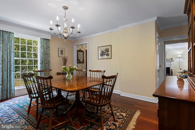 dining room with a chandelier, dark wood-type flooring, crown molding, and baseboards