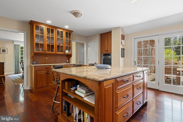 kitchen with stainless steel oven, dark wood-style flooring, recessed lighting, a kitchen island, and open shelves
