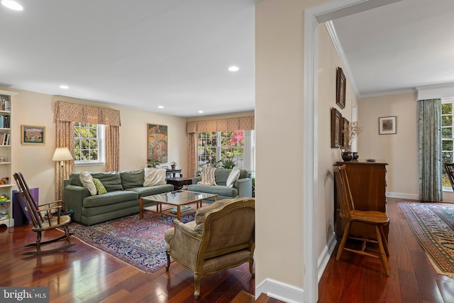 living area with hardwood / wood-style flooring, healthy amount of natural light, ornamental molding, recessed lighting, and baseboards