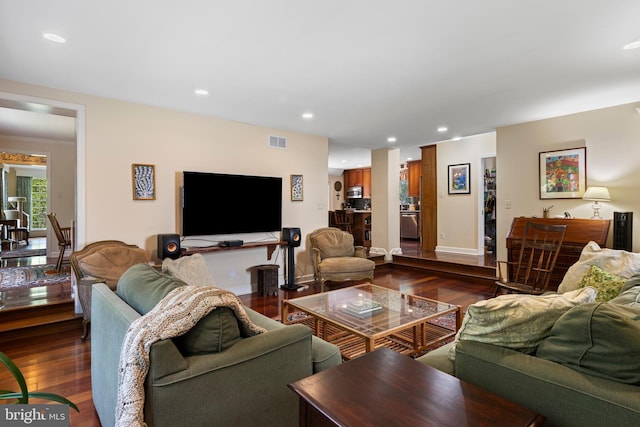 living room with dark wood finished floors, baseboards, and recessed lighting