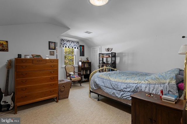 bedroom featuring lofted ceiling and carpet flooring