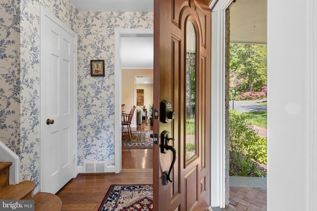foyer with wallpapered walls and stairs