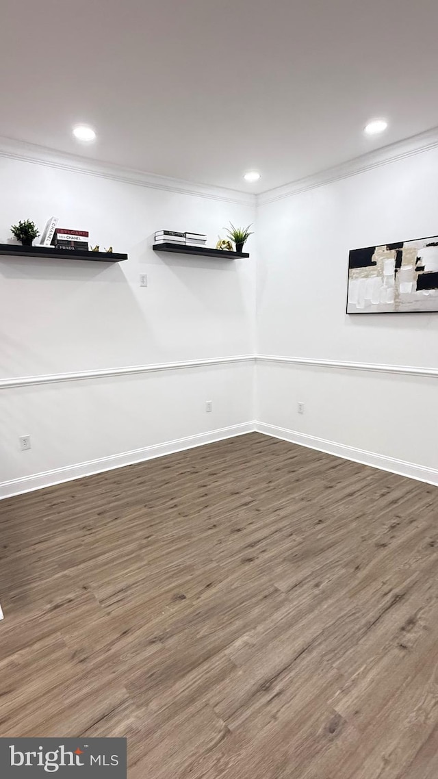 basement featuring crown molding, baseboards, recessed lighting, and wood finished floors