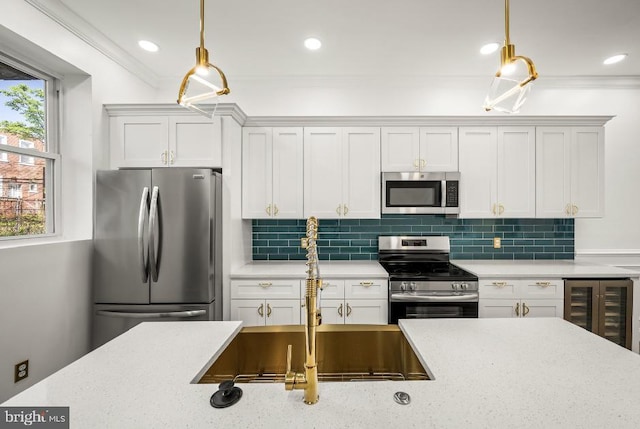 kitchen featuring crown molding, pendant lighting, tasteful backsplash, a sink, and stainless steel appliances