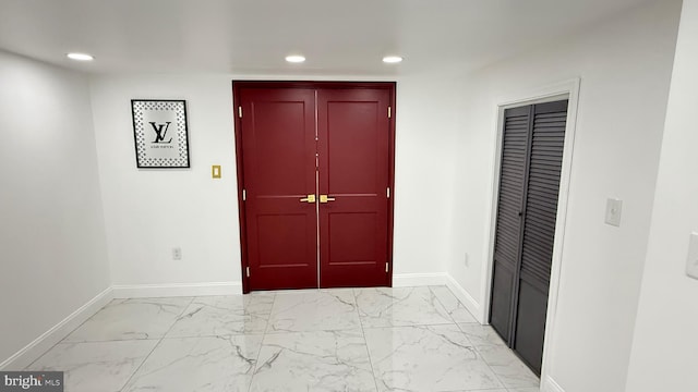 entryway featuring baseboards, recessed lighting, and marble finish floor