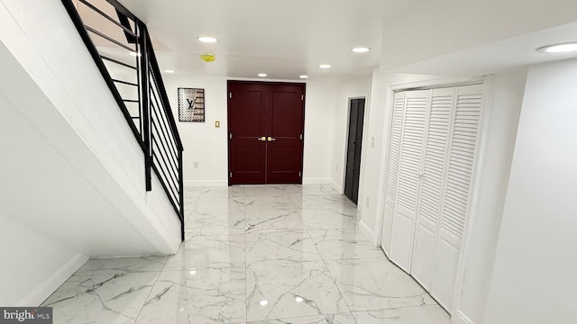 corridor with recessed lighting, baseboards, stairway, and marble finish floor