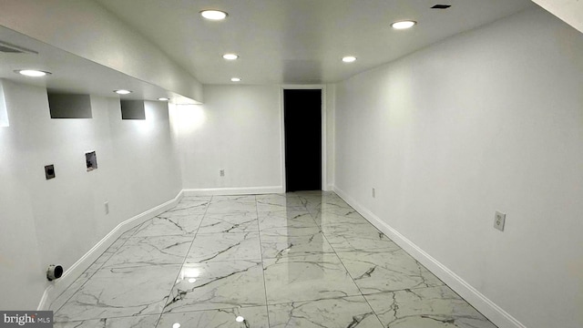 interior space featuring baseboards, recessed lighting, and marble finish floor