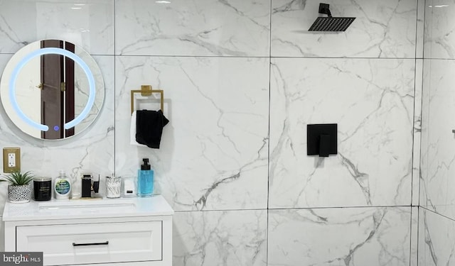 bathroom featuring vanity and a marble finish shower