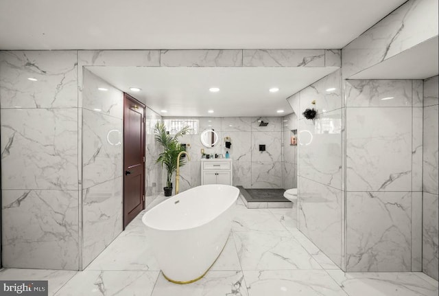 bathroom featuring vanity, marble finish floor, tile walls, a freestanding bath, and a marble finish shower