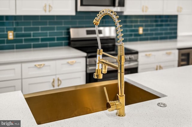 interior space featuring beverage cooler, decorative backsplash, white cabinetry, and electric stove