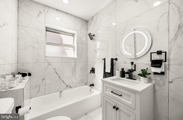 full bath with toilet, shower / washtub combination, tile walls, and vanity