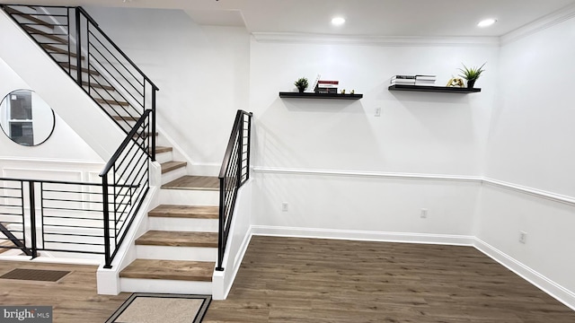 stairway featuring baseboards, recessed lighting, and wood finished floors