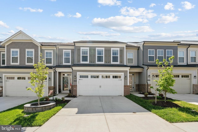 view of property featuring brick siding, an attached garage, and driveway