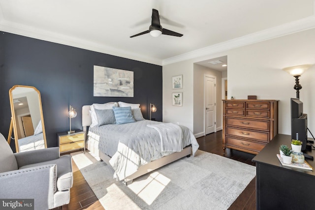 bedroom with crown molding, ceiling fan, baseboards, and dark wood-type flooring