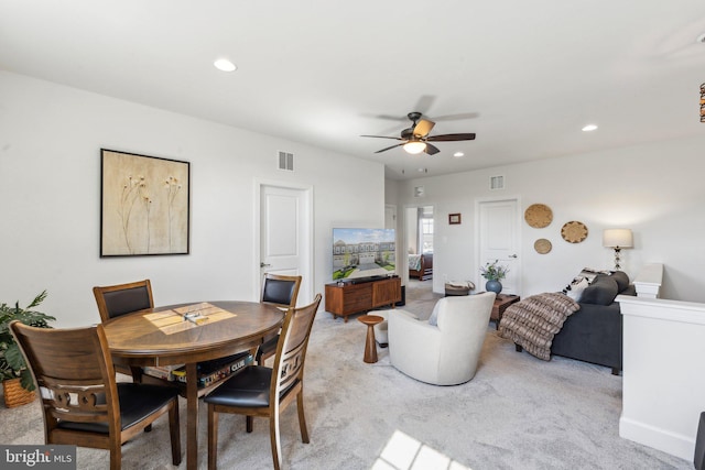 dining space featuring visible vents, a ceiling fan, recessed lighting, and light colored carpet