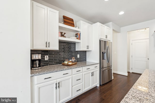 kitchen featuring backsplash, stainless steel refrigerator with ice dispenser, open shelves, dark wood finished floors, and white cabinetry