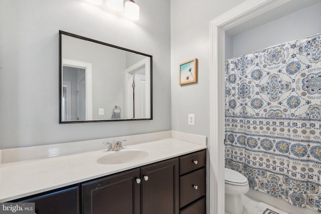 bathroom with vanity, tile patterned flooring, toilet, and a shower with curtain