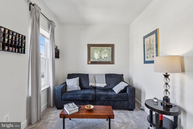 carpeted living room with baseboards